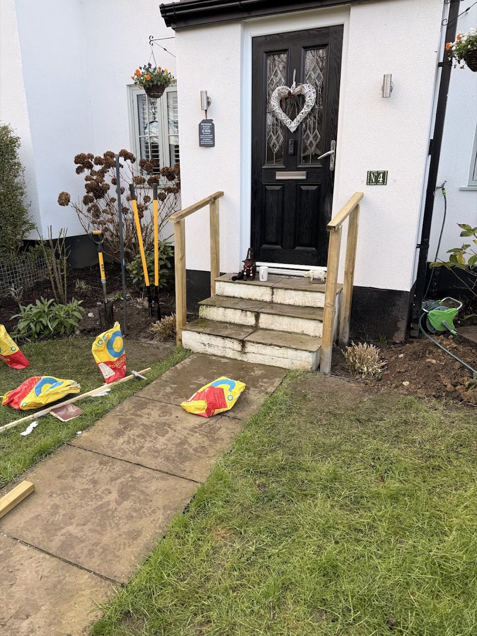 New timber handrails fitted to front-door steps.