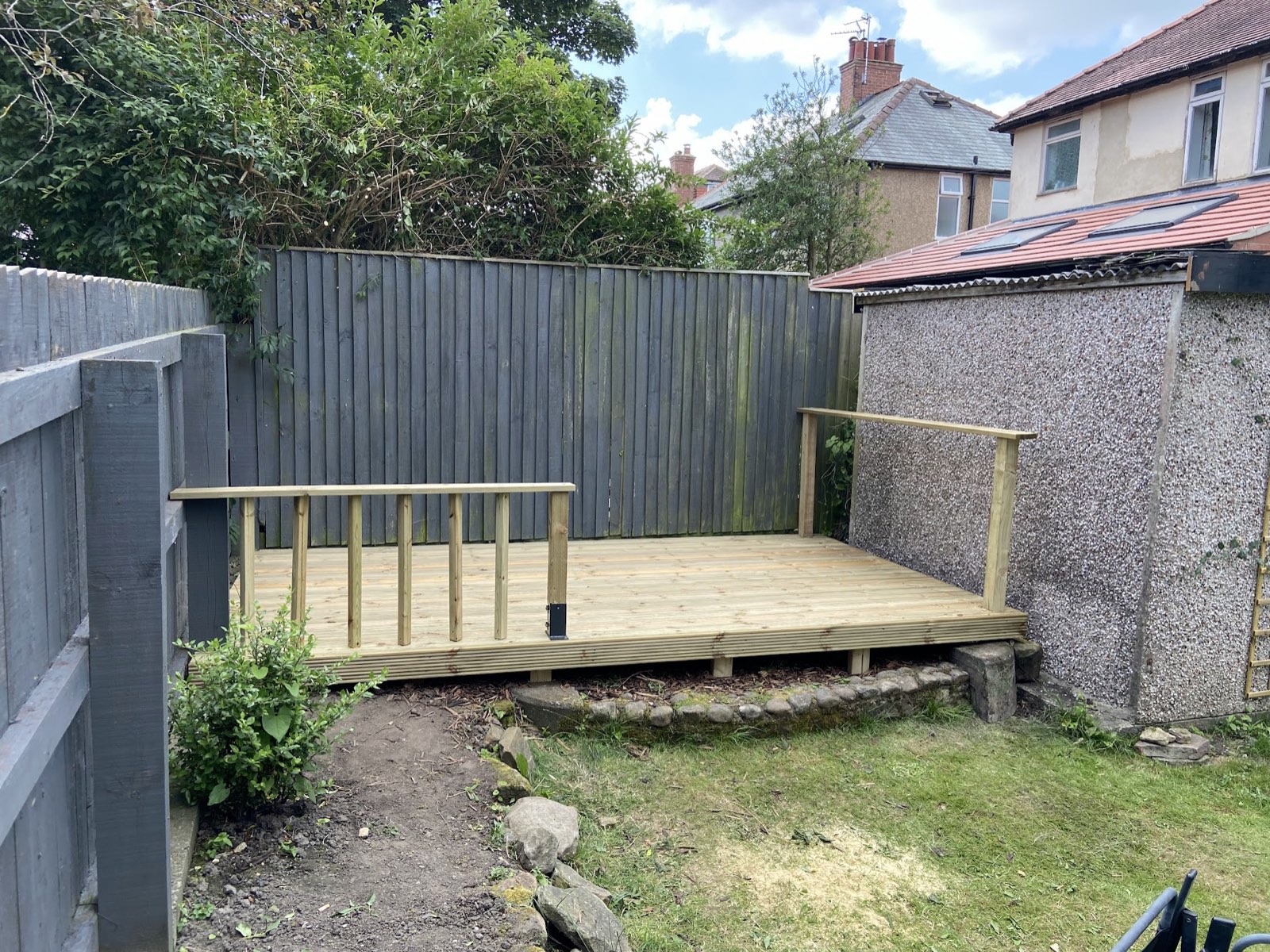 The finished raised timber deck with handrail.