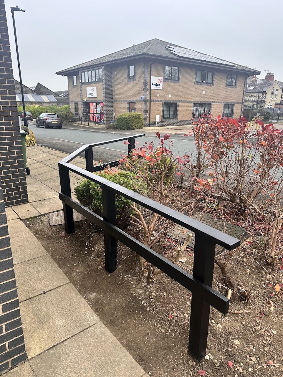 The finished black metal handrail along the front path.