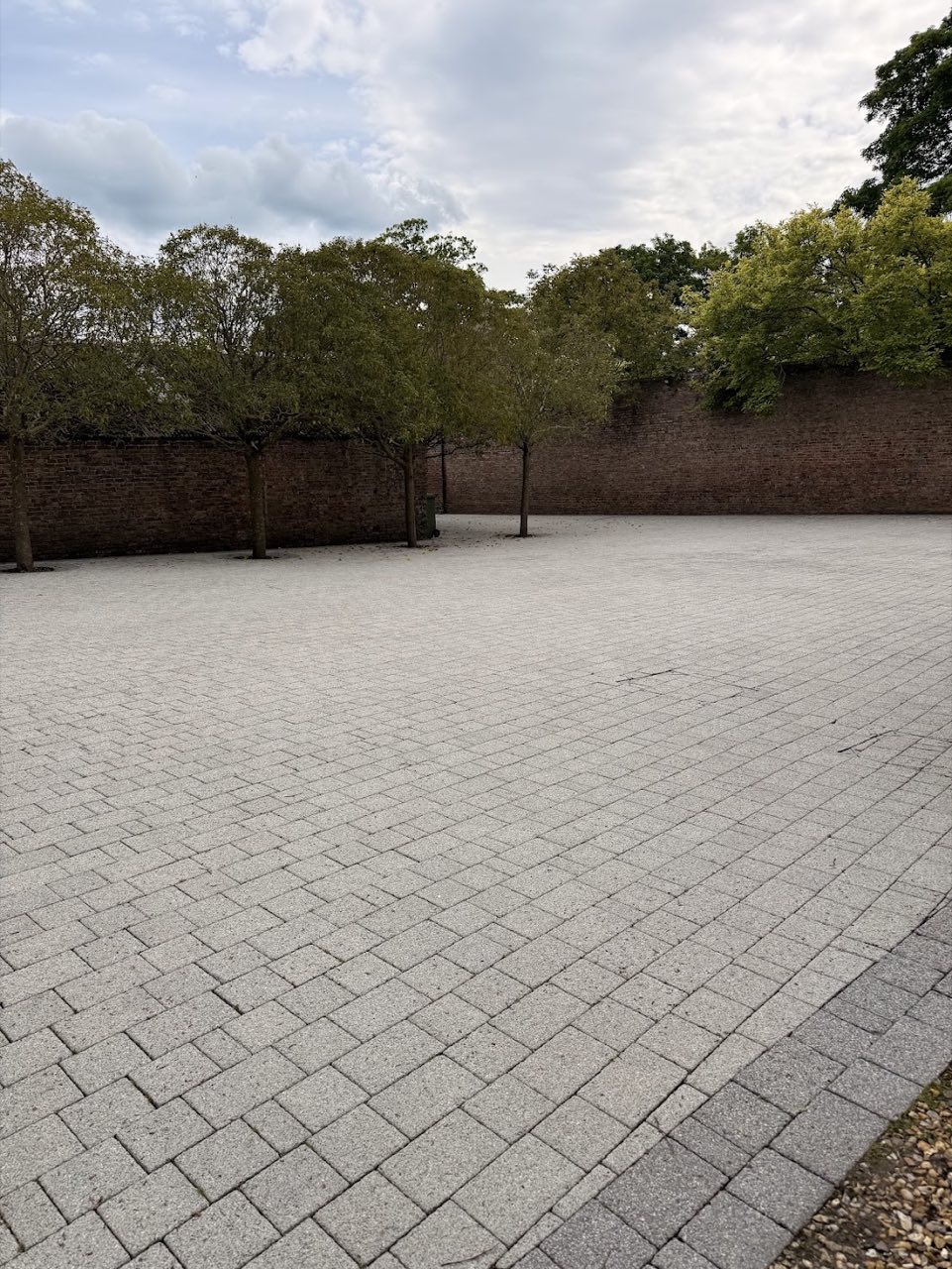 Large block-paved courtyard cleaned by jet washing.